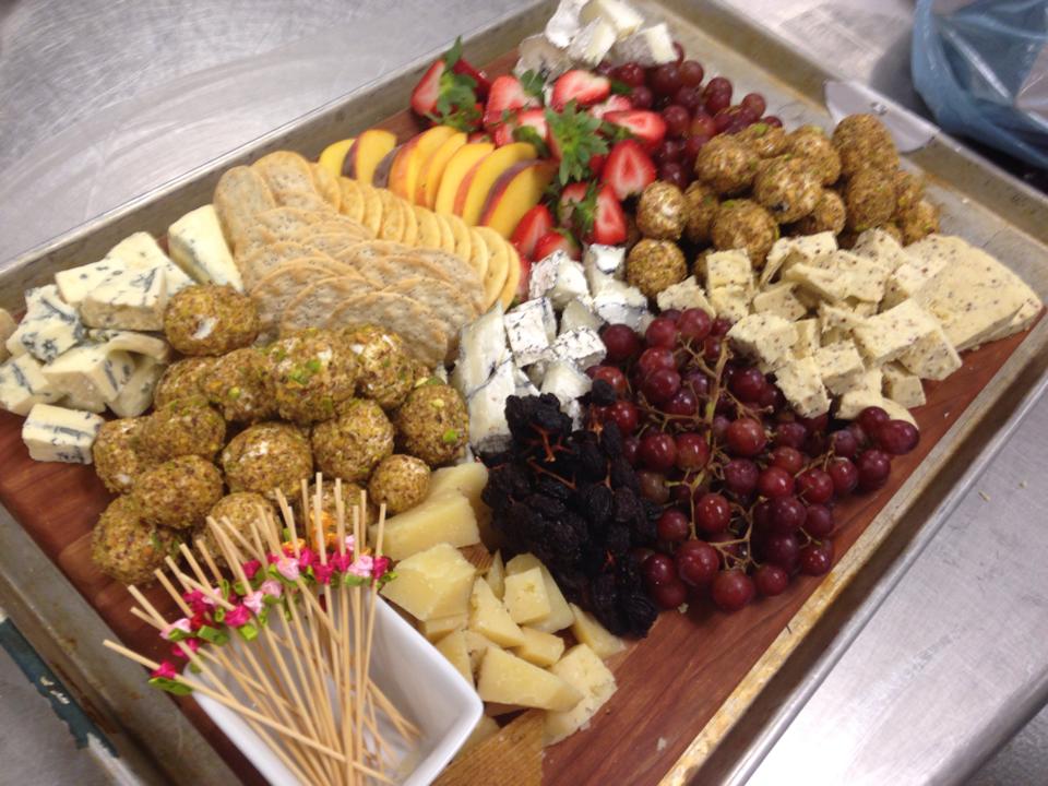 Artisan cheese and fruit board with crackers and seasonal garnish