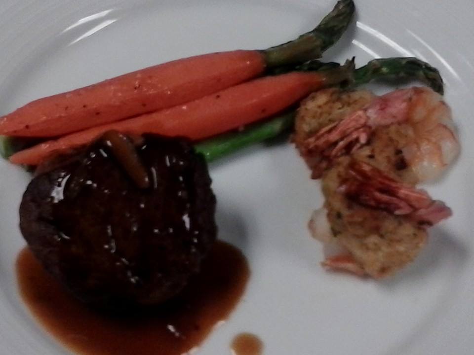 Filet mignon with herb shrimp, glazed carrots, and asparagus